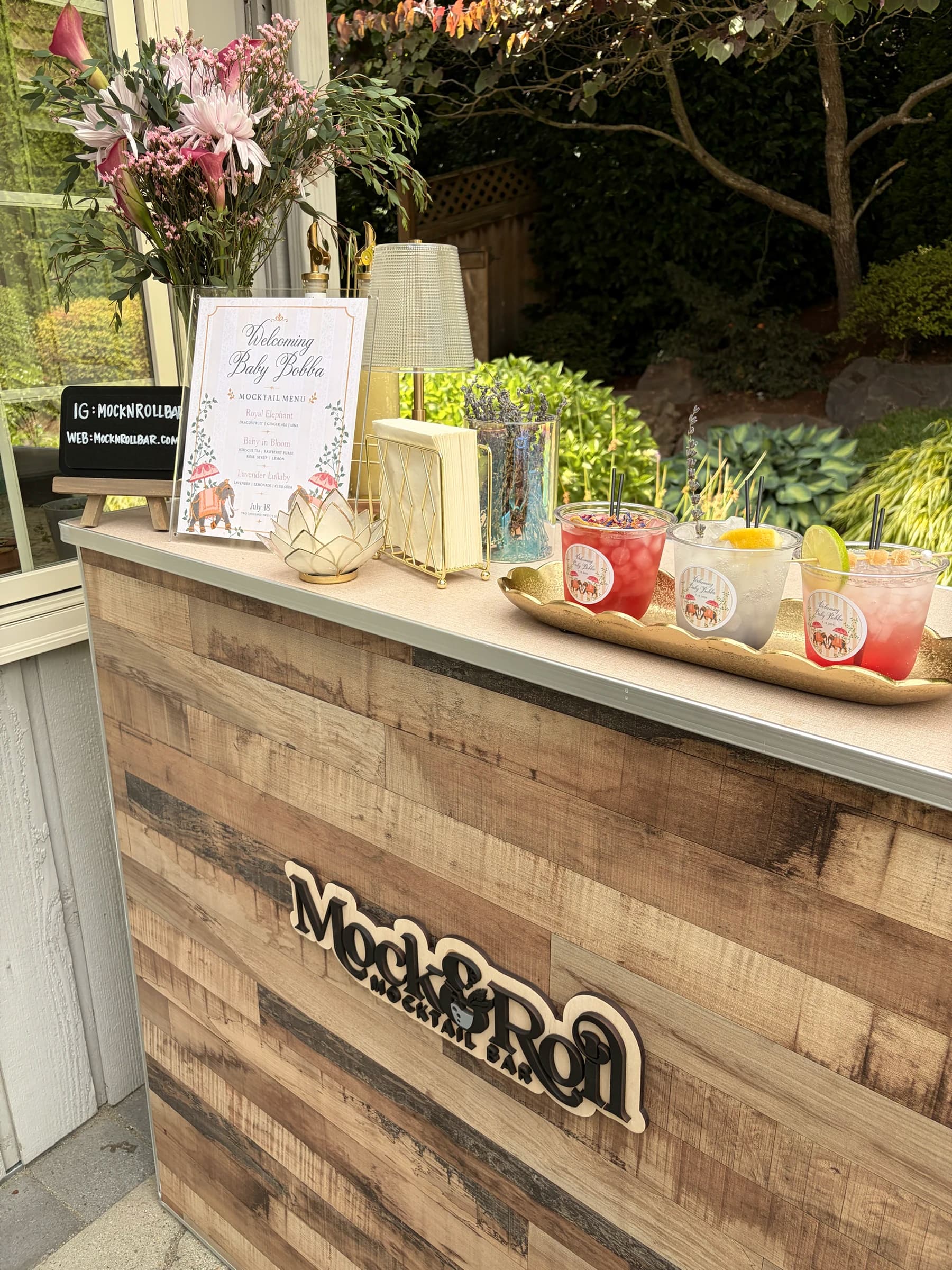 Guests gathered around a curated mocktail bar at an evening event